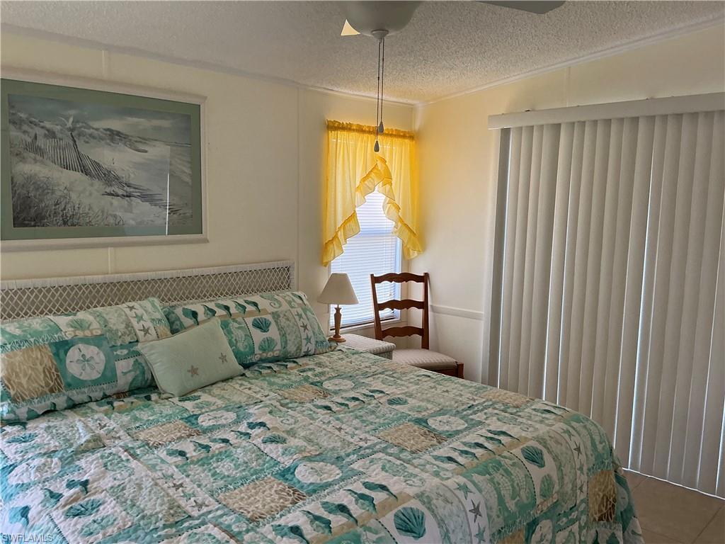 237 Eagle Road, Unit 237 Naples, FL 34114 - Photo 15 of 27 a bedroom with a bed and a painting on the wall
