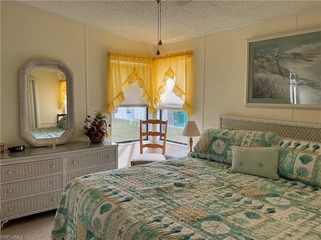 237 Eagle Road, Unit 237 Naples, FL 34114 - Photo 16 of 27 a bed room with a bed and a mirror