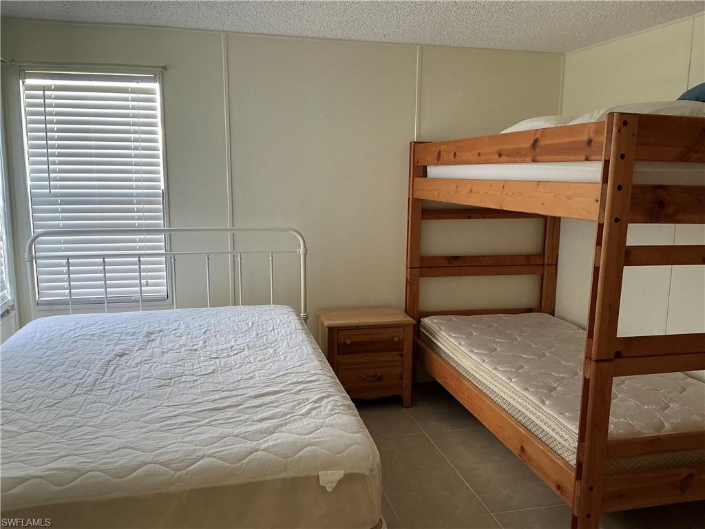 237 Eagle Road, Unit 237 Naples, FL 34114 - Photo 17 of 27 a bedroom with a bed and a window