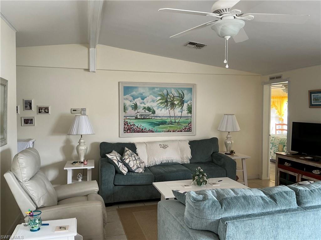 237 Eagle Road, Unit 237 Naples, FL 34114 - Photo 20 of 27 a living room with furniture and a flat screen tv