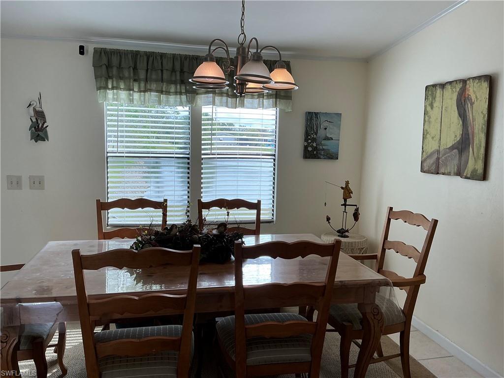 237 Eagle Road, Unit 237 Naples, FL 34114 - Photo 23 of 27 a dining room with furniture and window