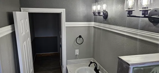 a bathroom with a shower and a sink