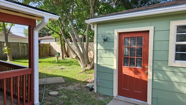 a view of a house with a backyard
