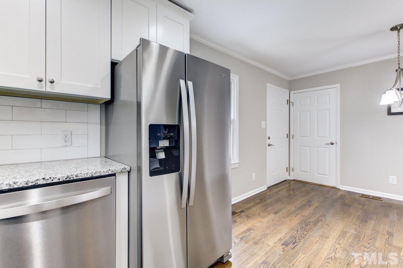 2314 Glascock Street Raleigh, NC 27610 - Photo 11 of 25 a kitchen with stainless steel appliances granite countertop a refrigerator and a stove