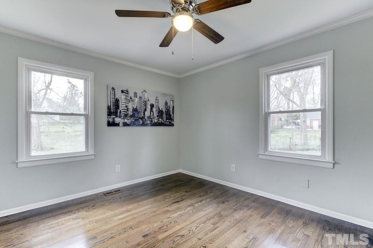 2314 Glascock Street Raleigh, NC 27610 - Photo 13 of 25 a view of empty room with wooden floor and fan