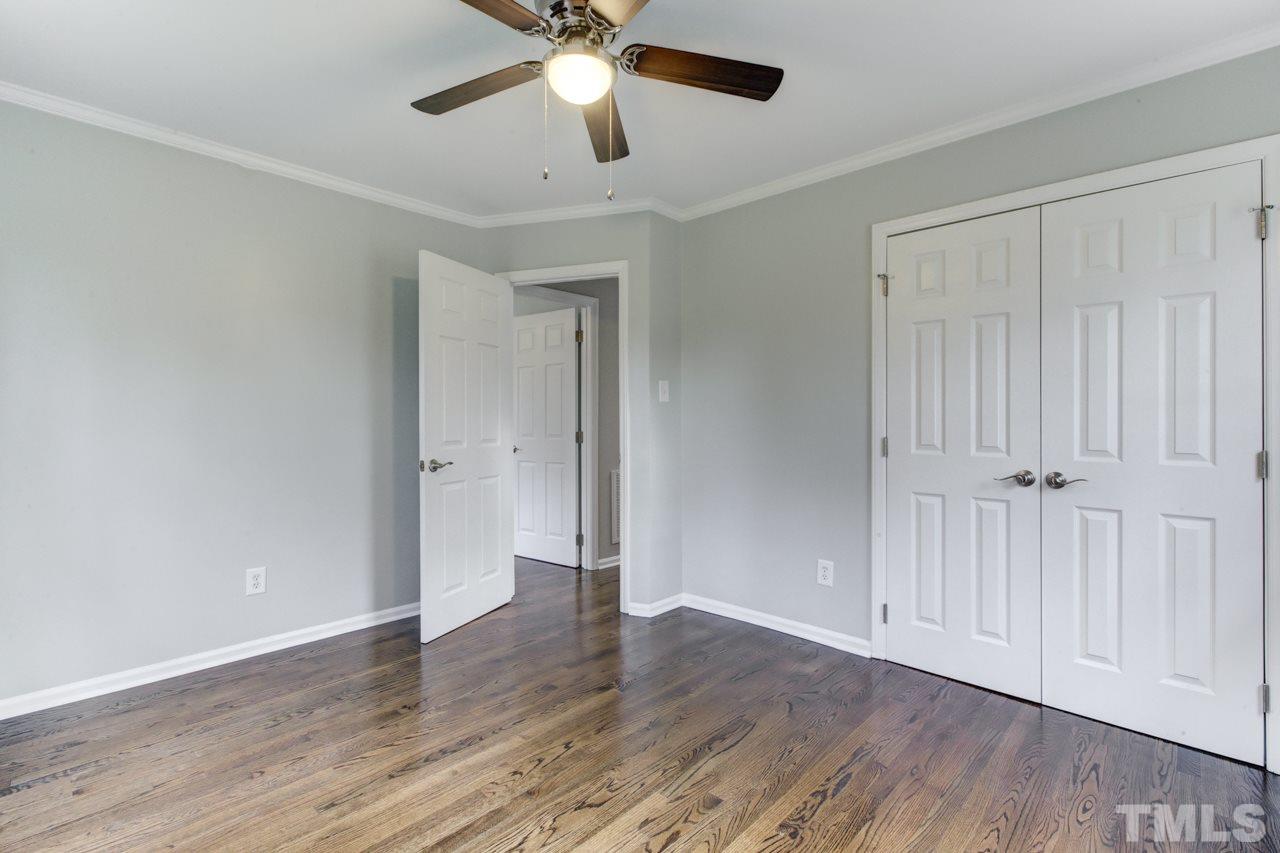 2314 Glascock Street Raleigh, NC 27610 - Photo 14 of 25 an empty room with wooden floor and windows