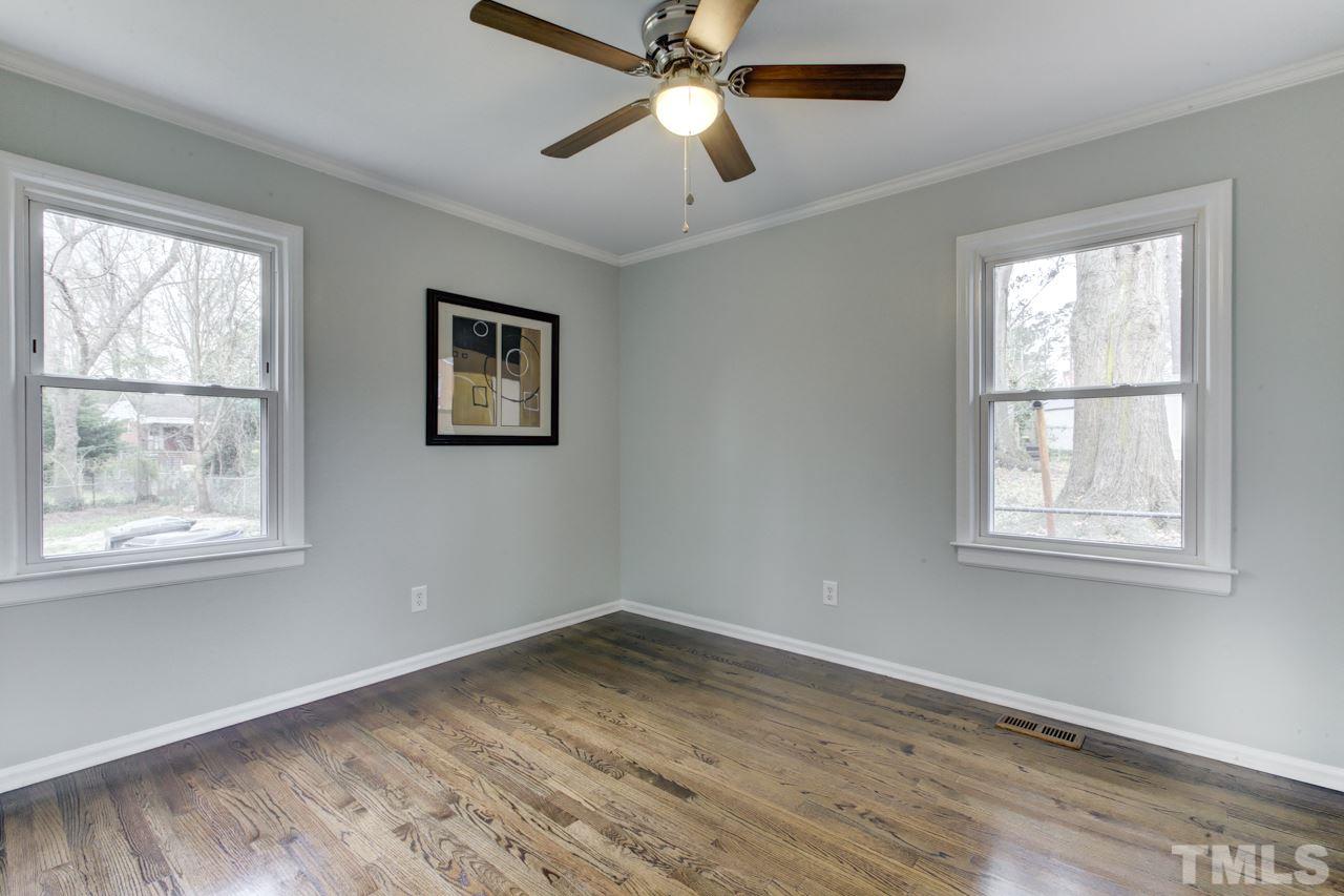 2314 Glascock Street Raleigh, NC 27610 - Photo 15 of 25 a view of empty room with wooden floor and fan
