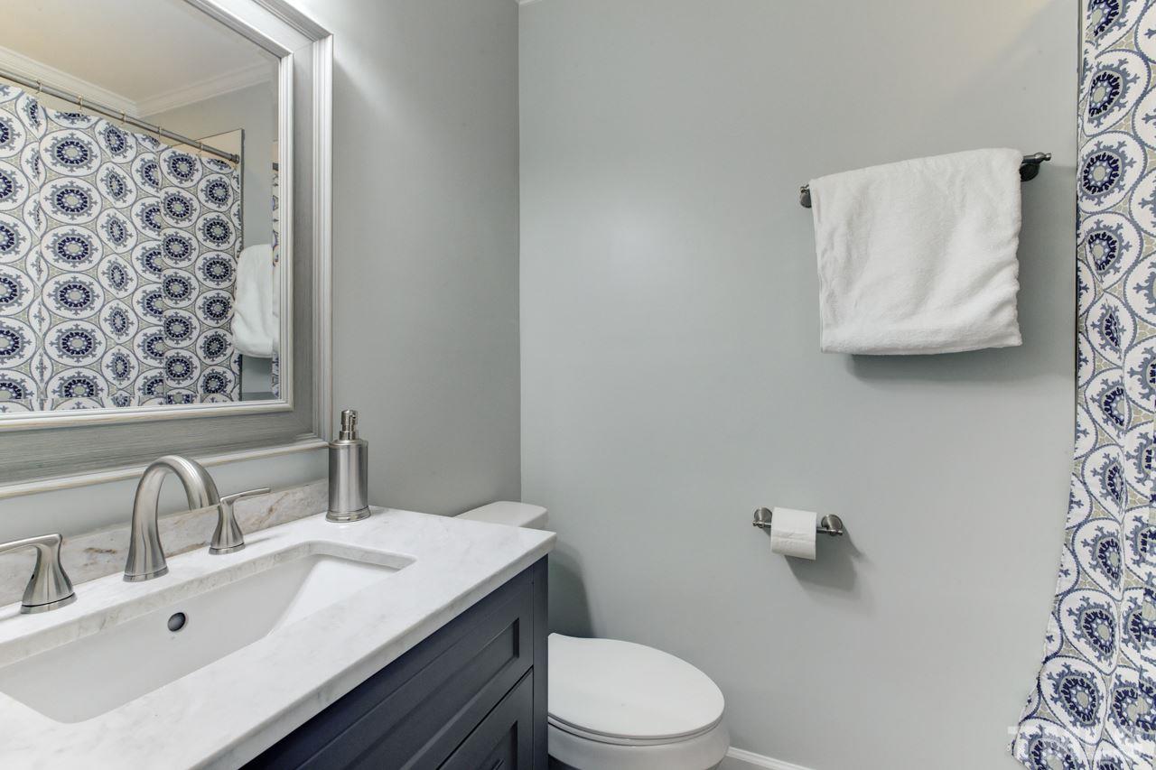 2314 Glascock Street Raleigh, NC 27610 - Photo 17 of 25 a bathroom with a sink mirror vanity and toilet
