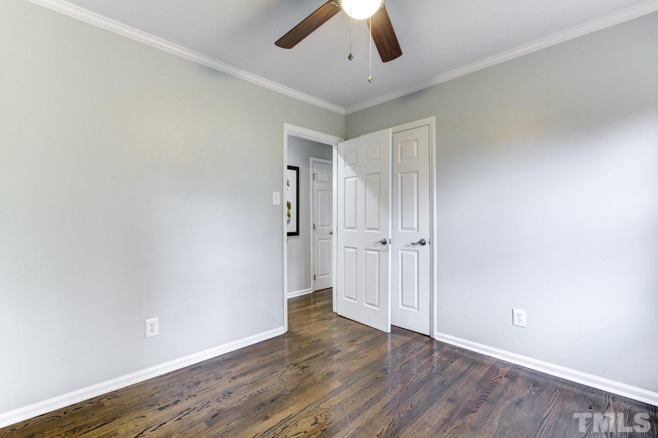 2314 Glascock Street Raleigh, NC 27610 - Photo 19 of 25 an empty room with wooden floor and ceiling fan