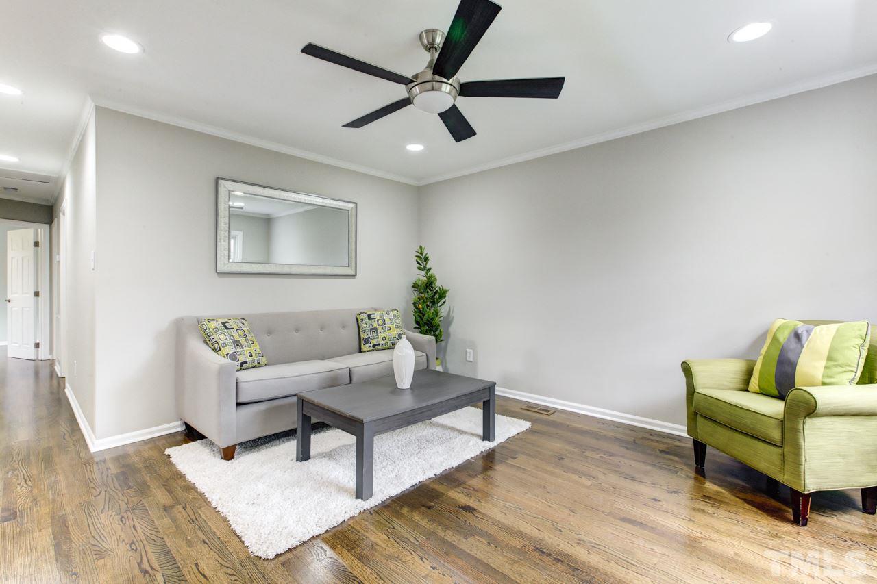 2314 Glascock Street Raleigh, NC 27610 - Photo 4 of 25 a living room with furniture and a potted plant
