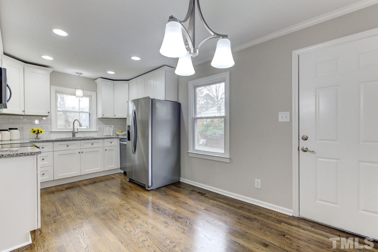 2314 Glascock Street Raleigh, NC 27610 - Photo 7 of 25 a kitchen with a refrigerator a sink and cabinets