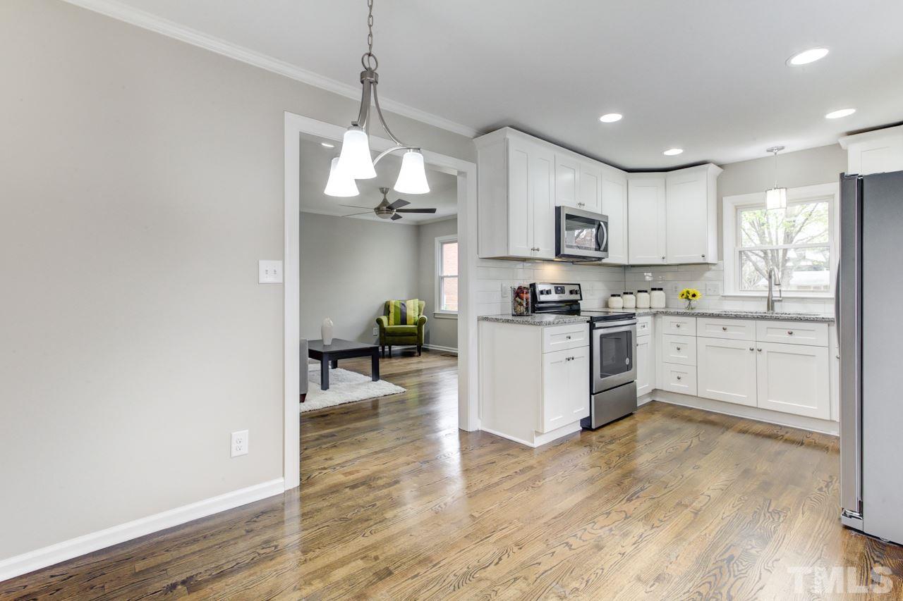 2314 Glascock Street Raleigh, NC 27610 - Photo 8 of 25 a kitchen with white cabinets and appliances