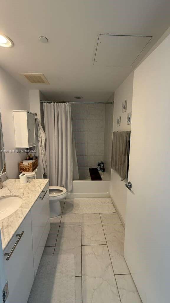 951 Brickell Avenue, Unit 3002 Miami, FL 33131 - Photo 12 of 25 a view of a kitchen with a sink and a refrigerator