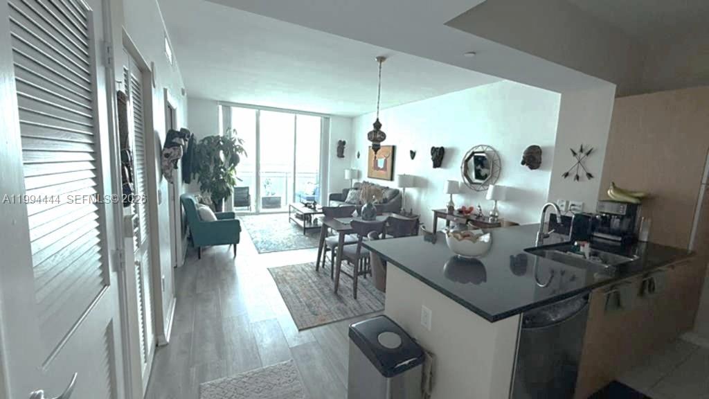 951 Brickell Avenue, Unit 3002 Miami, FL 33131 - Photo 15 of 25 a view of a dining room with furniture and a chandelier