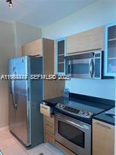 951 Brickell Avenue, Unit 3002 Miami, FL 33131 - Photo 8 of 25 a stove top oven sitting inside of a kitchen