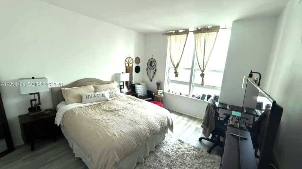951 Brickell Avenue, Unit 3002 Miami, FL 33131 - Photo 10 of 25 a bed sitting in a bedroom next to a window