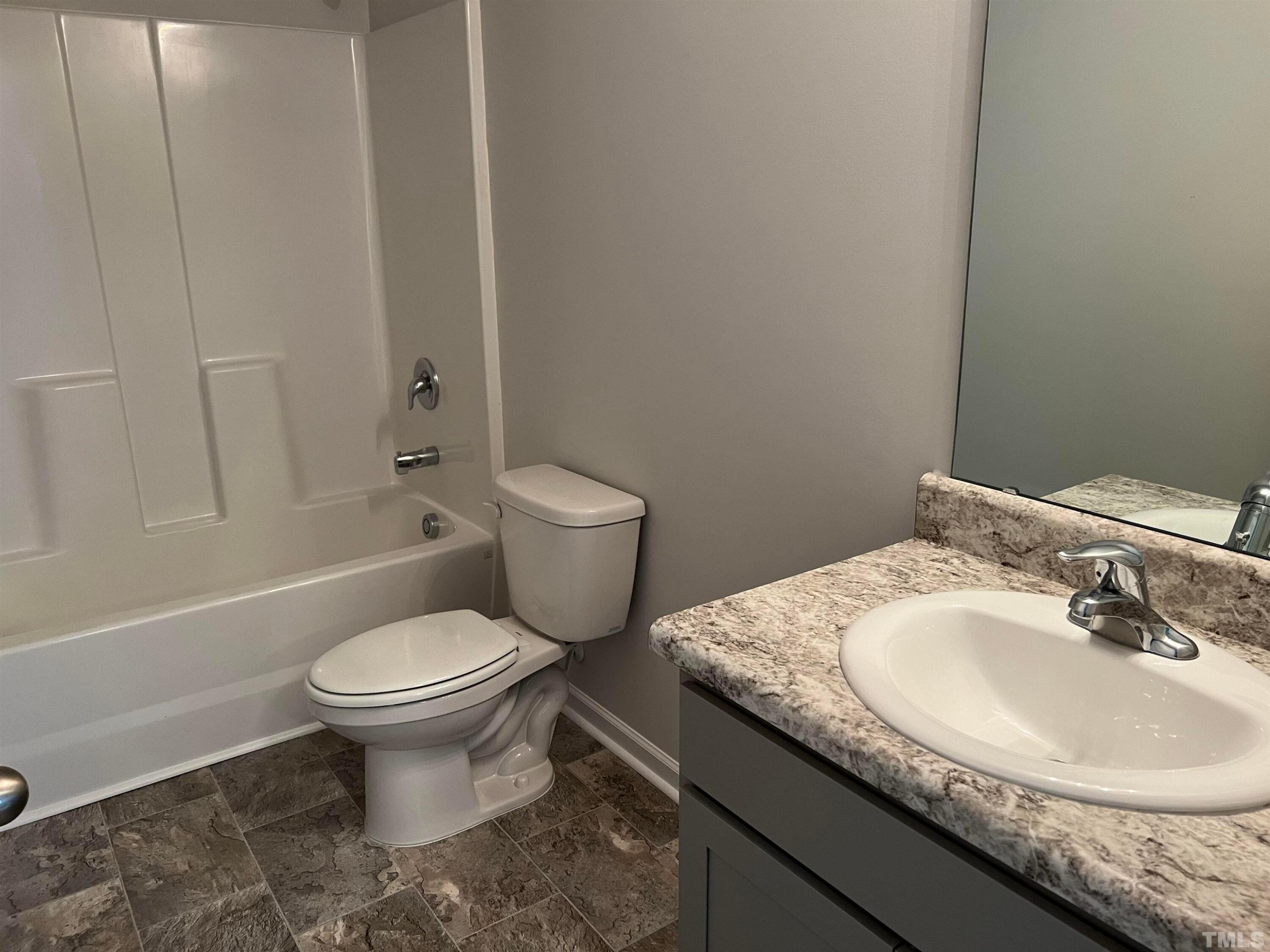 179 Maple Tree Lane Clayton, NC 27527 - Photo 18 of 18 a bathroom with a granite countertop sink toilet and a mirror