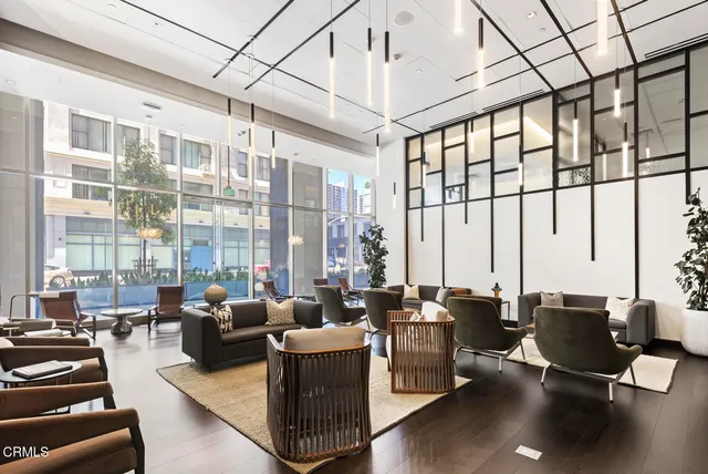 a living room with furniture city view and large windows