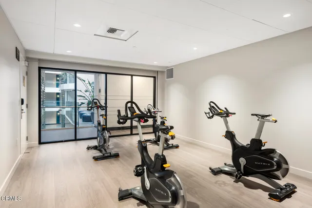 a dining room with furniture and a potted plant