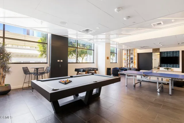 a kitchen with stainless steel appliances kitchen island granite countertop a refrigerator and a stove top oven