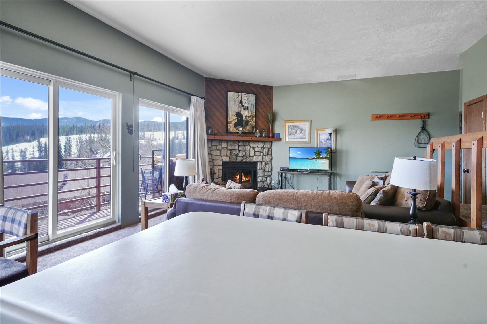 9800 Ryan Gulch Road, Unit 108 Silverthorne, CO 80498 - Photo 12 of 33 a living room with furniture and a fireplace