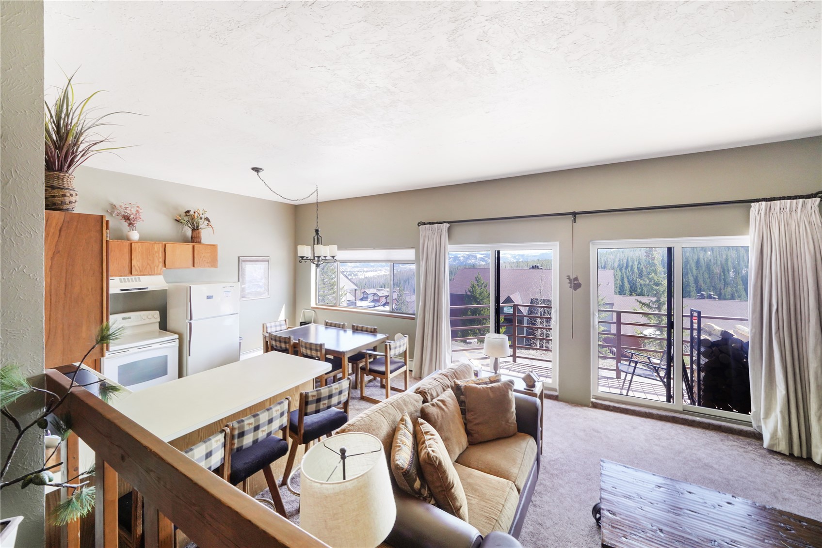 9800 Ryan Gulch Road, Unit 108 Silverthorne, CO 80498 - Photo 23 of 33 a living room with furniture and large windows