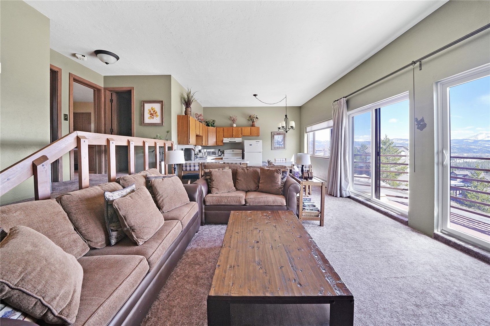 9800 Ryan Gulch Road, Unit 108 Silverthorne, CO 80498 - Photo 10 of 33 a living room with furniture and a table