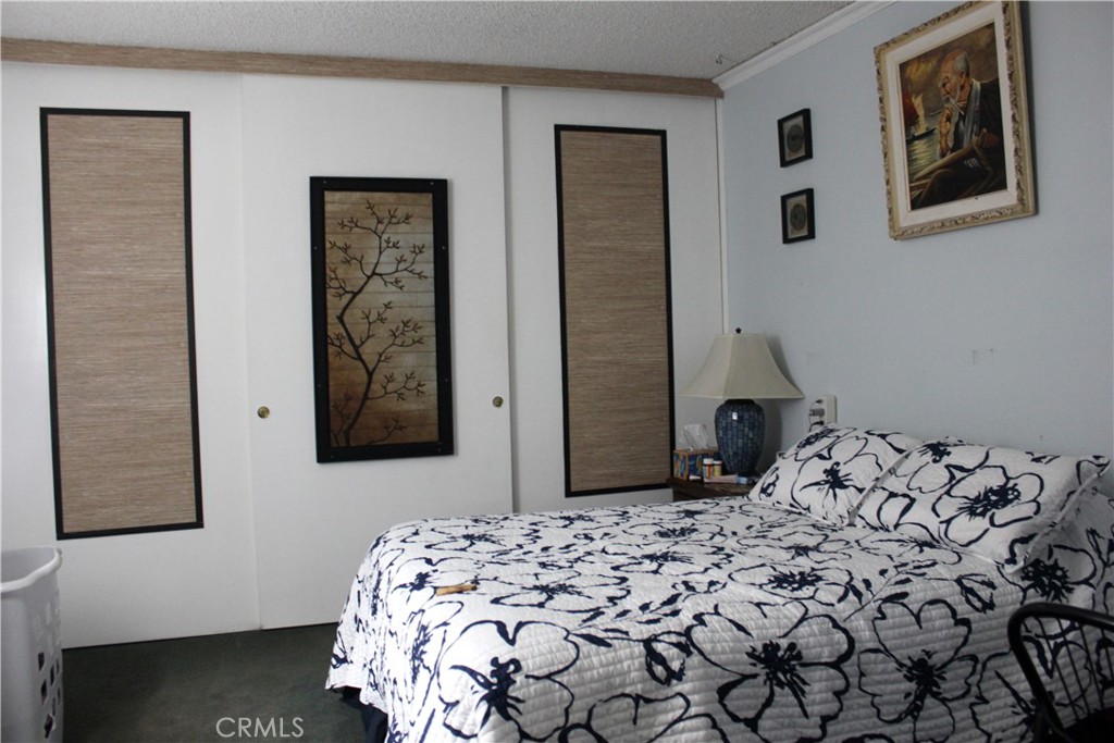 5911 Green Valley Road Riverside, CA 92504 - Photo 9 of 24 a bedroom with a bed and a window