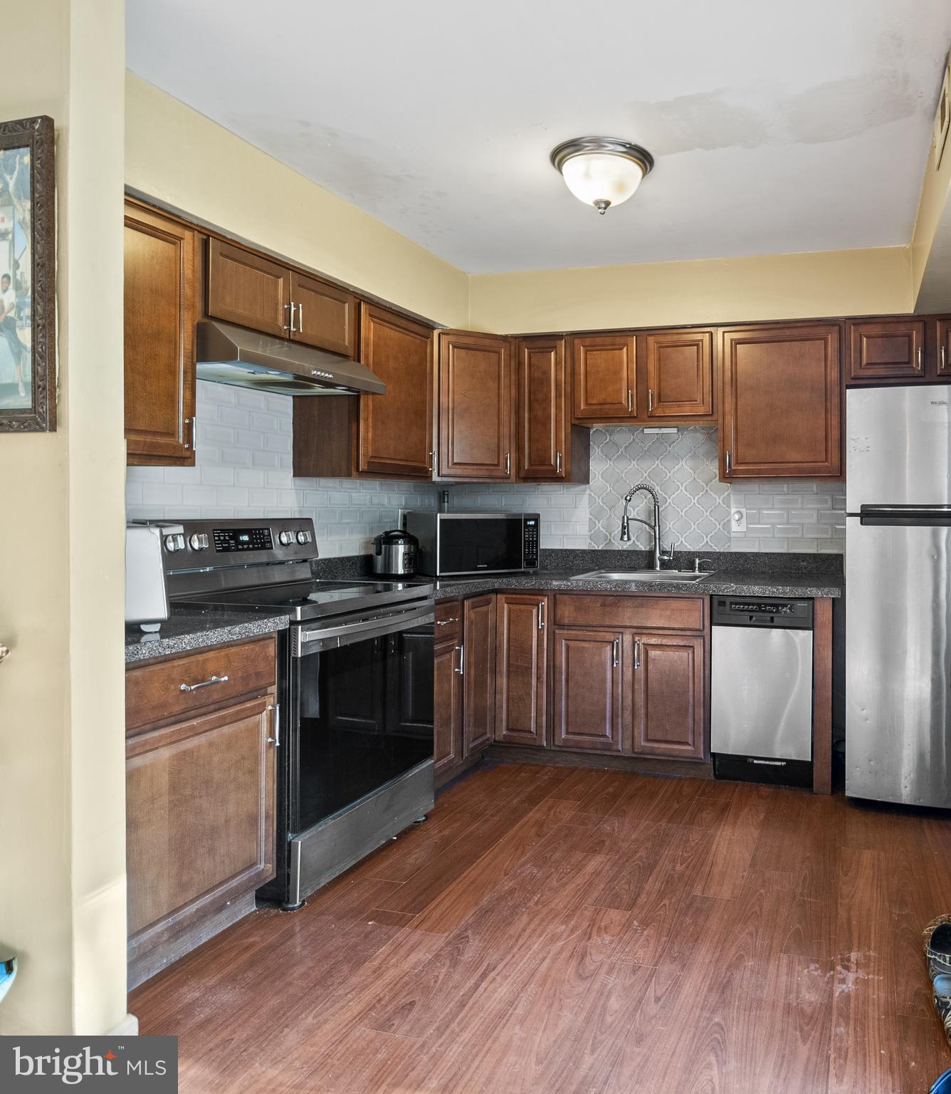 29 Sycamore Court Lumberton, NJ 08048 - Photo 7 of 15 a kitchen with stainless steel appliances granite countertop a stove a sink and a refrigerator