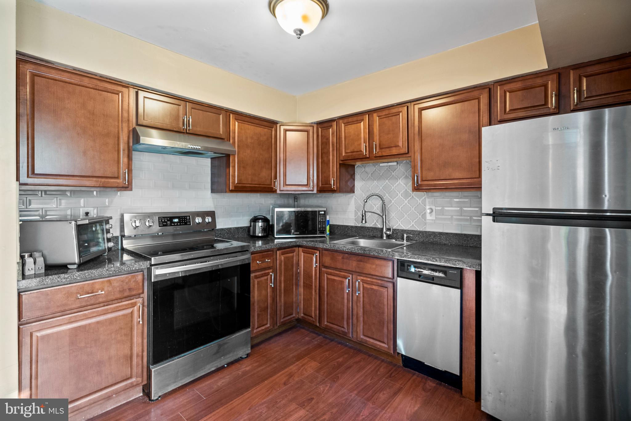 29 Sycamore Court Lumberton, NJ 08048 - Photo 8 of 15 a kitchen with stainless steel appliances granite countertop a stove a washer and dryer