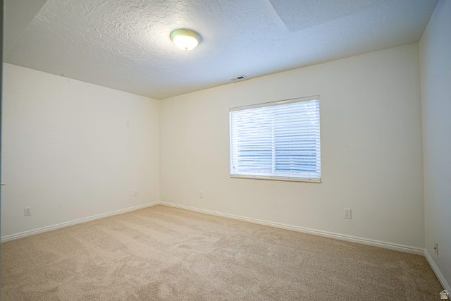 1433 Forge Way Draper, UT 84020 - Photo 25 of 29 Carpeted room featuring a single window with horizontal blinds, white walls, and a ceiling-mounted light fixture