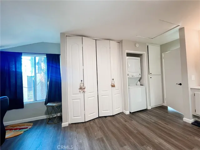 a view of a room with wooden floor and windows