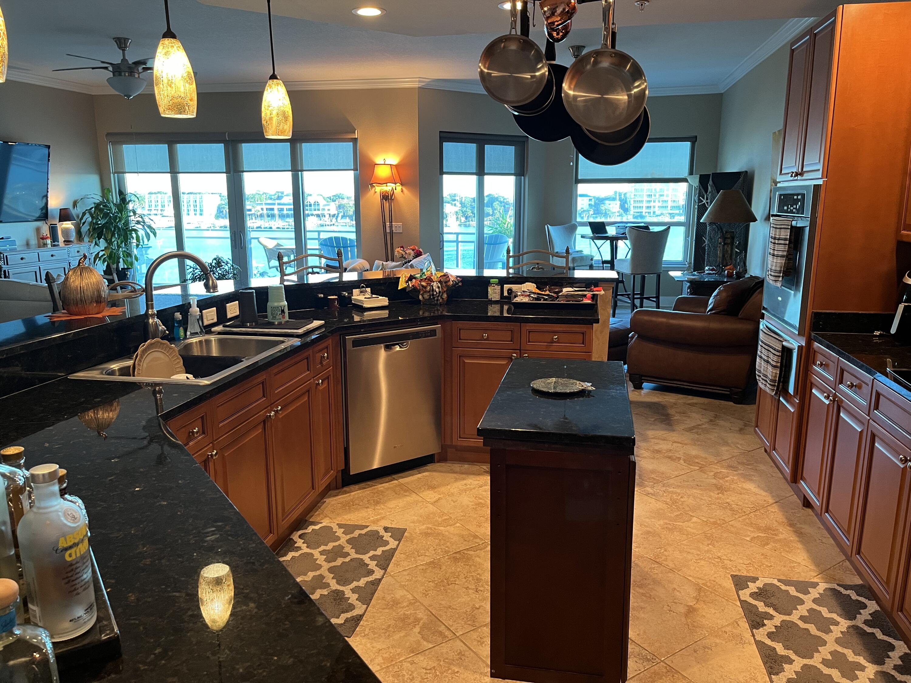 211 Durango Road, Unit 414 Destin, FL 32541 - Photo 16 of 50 a kitchen with stainless steel appliances kitchen island granite countertop a sink and a stove