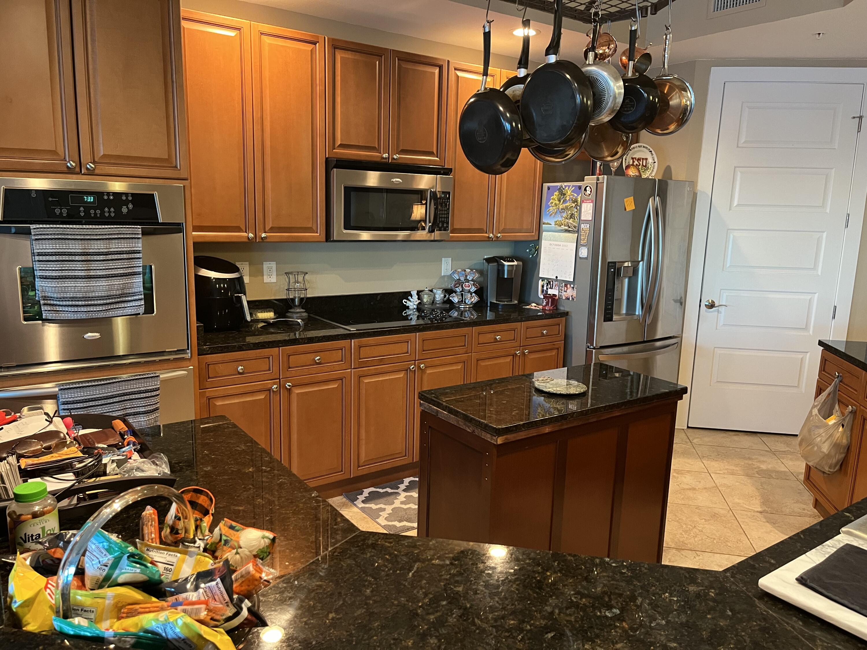 211 Durango Road, Unit 414 Destin, FL 32541 - Photo 18 of 50 a kitchen with stainless steel appliances granite countertop a stove a sink and a microwave