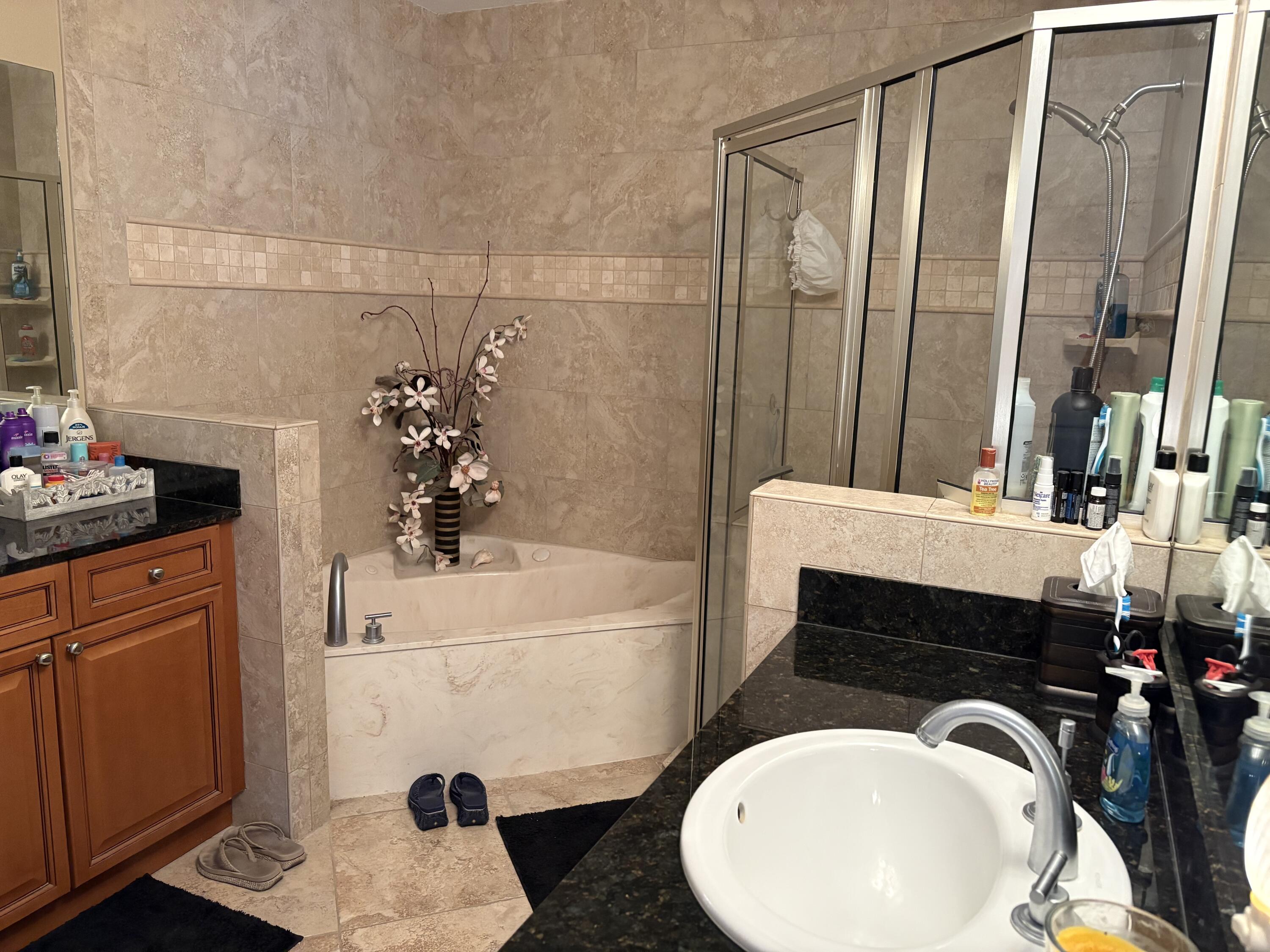 211 Durango Road, Unit 414 Destin, FL 32541 - Photo 24 of 50 a bathroom with a sink a bathtub and a shower