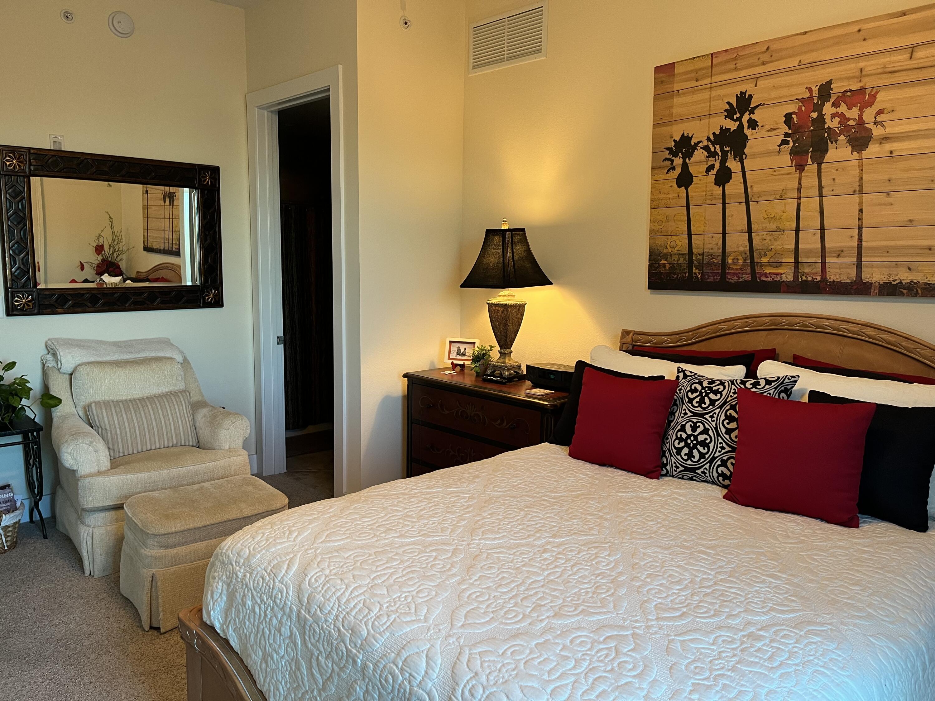 211 Durango Road, Unit 414 Destin, FL 32541 - Photo 27 of 50 a bedroom with a large bed and a painting on the wall