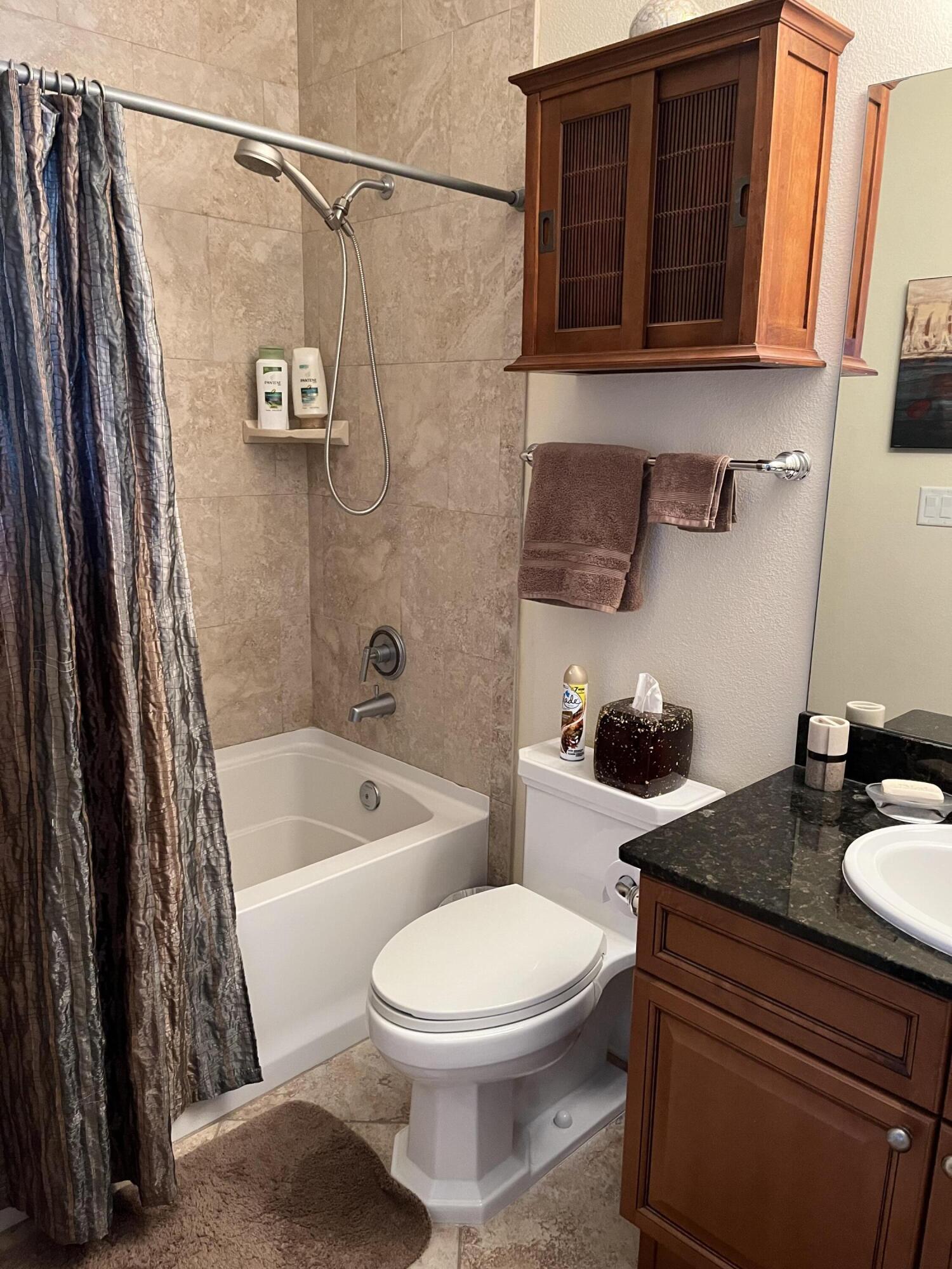 211 Durango Road, Unit 414 Destin, FL 32541 - Photo 29 of 50 a bathroom with a sink a toilet and shower