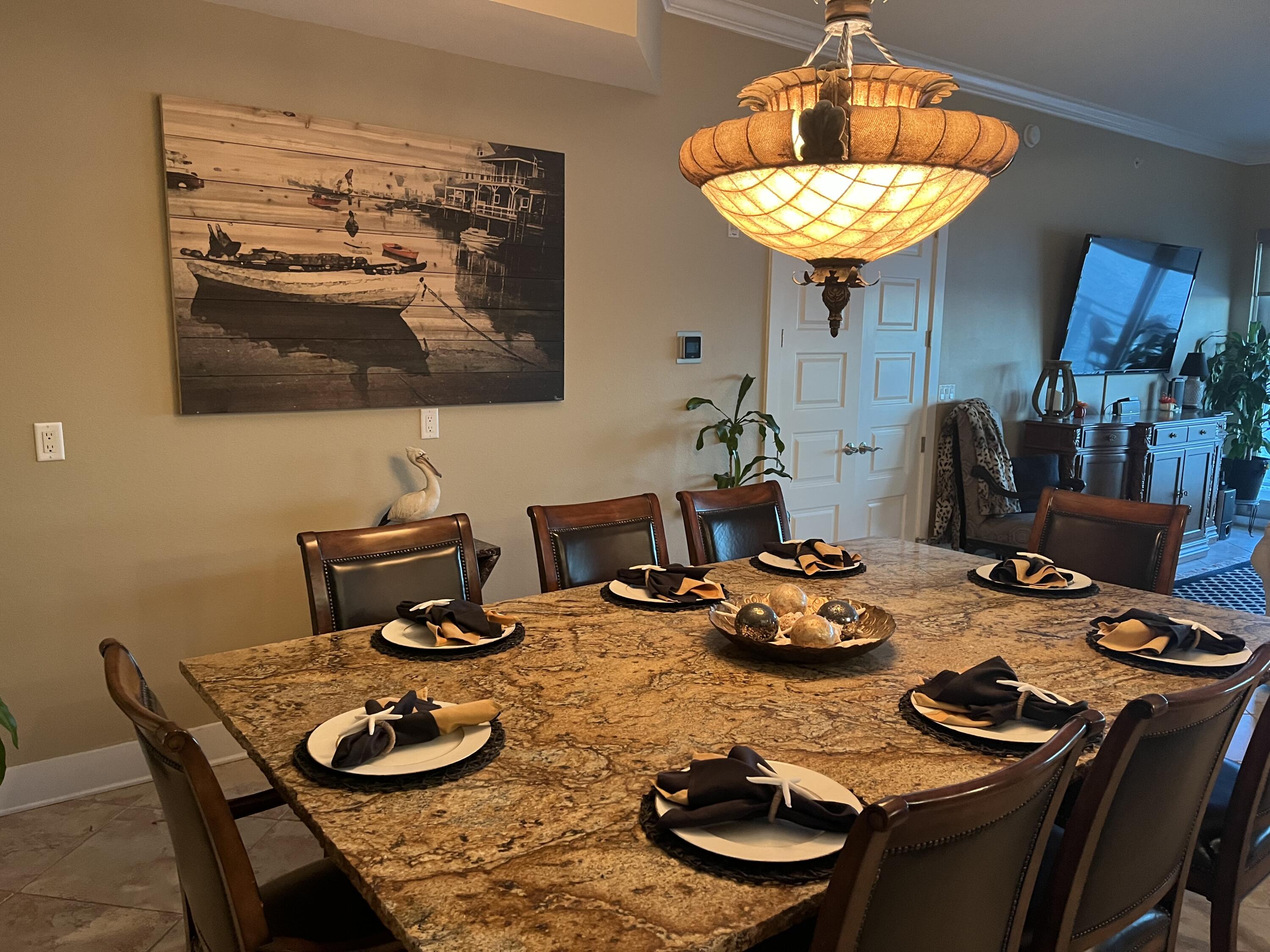 211 Durango Road, Unit 414 Destin, FL 32541 - Photo 7 of 50 a table and dining room with furniture