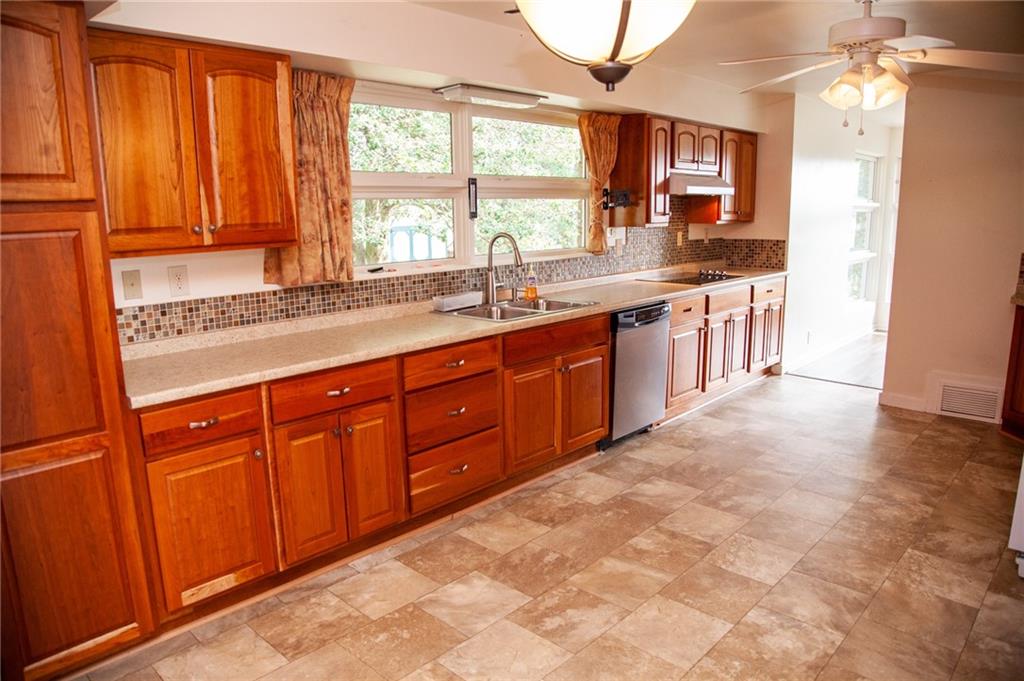 641 Morgantown Road Uniontown, PA 15401 - Photo 10 of 38 a large kitchen with kitchen island granite countertop a sink cabinets and a large window
