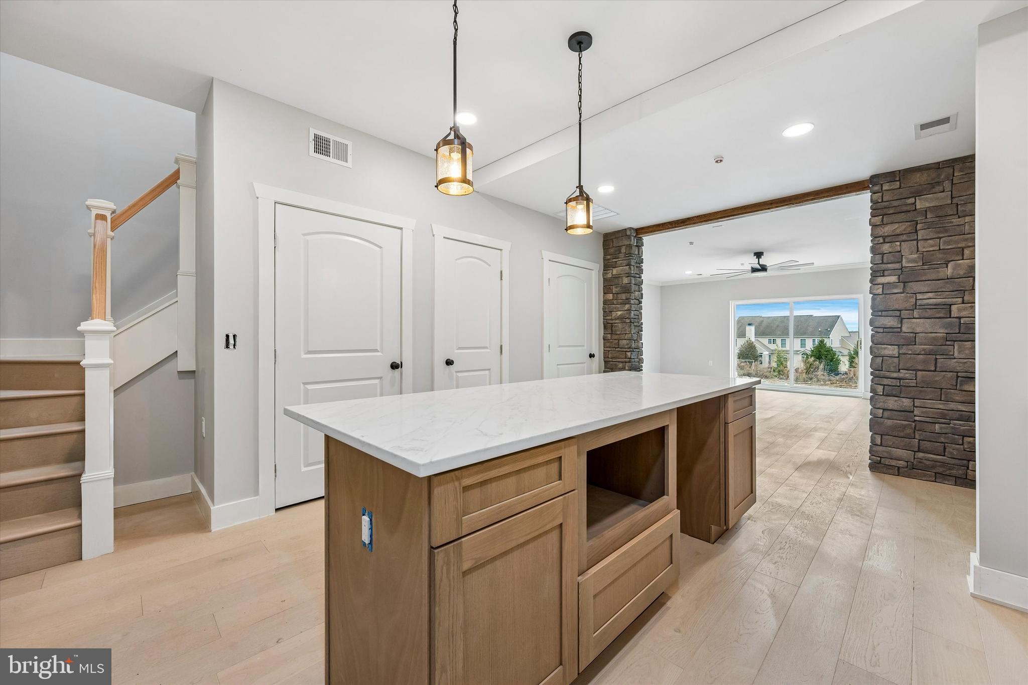 449 Greenridge Road Glenmoore, PA 19343 - Photo 3 of 21 a kitchen with kitchen island a sink a stove and a chandelier