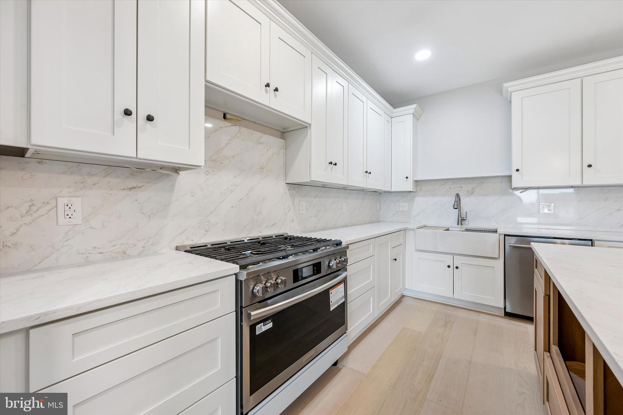449 Greenridge Road Glenmoore, PA 19343 - Photo 5 of 21 a kitchen with granite countertop white cabinets and stainless steel appliances
