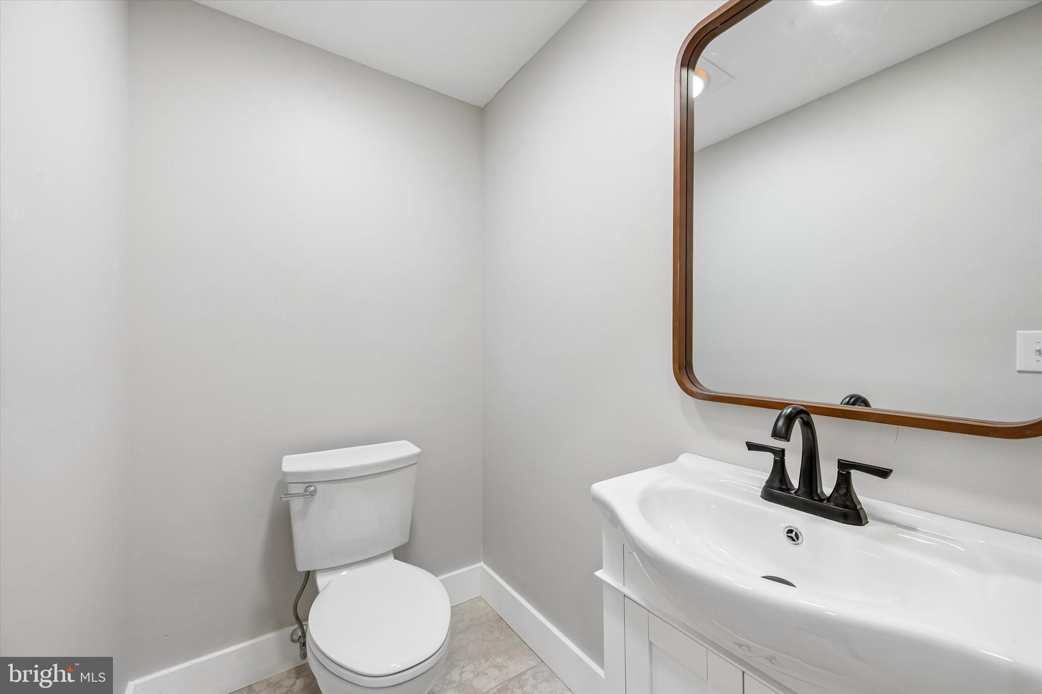 449 Greenridge Road Glenmoore, PA 19343 - Photo 8 of 21 a bathroom with a toilet sink and mirror