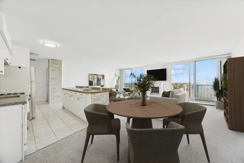 a view of a dining room with furniture and a kitchen