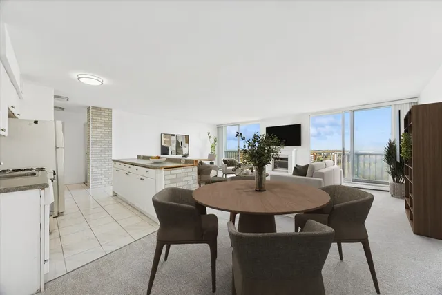 a view of a dining room with furniture and a kitchen