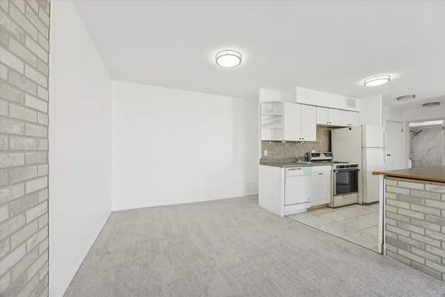a kitchen with cabinets and white appliances