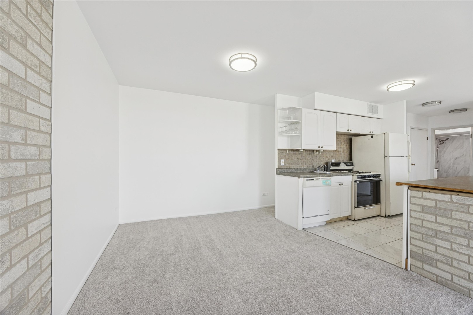 20 North Tower Road, Unit 12L Oak Brook, IL 60523 - Photo 9 of 16 a kitchen with cabinets and white appliances