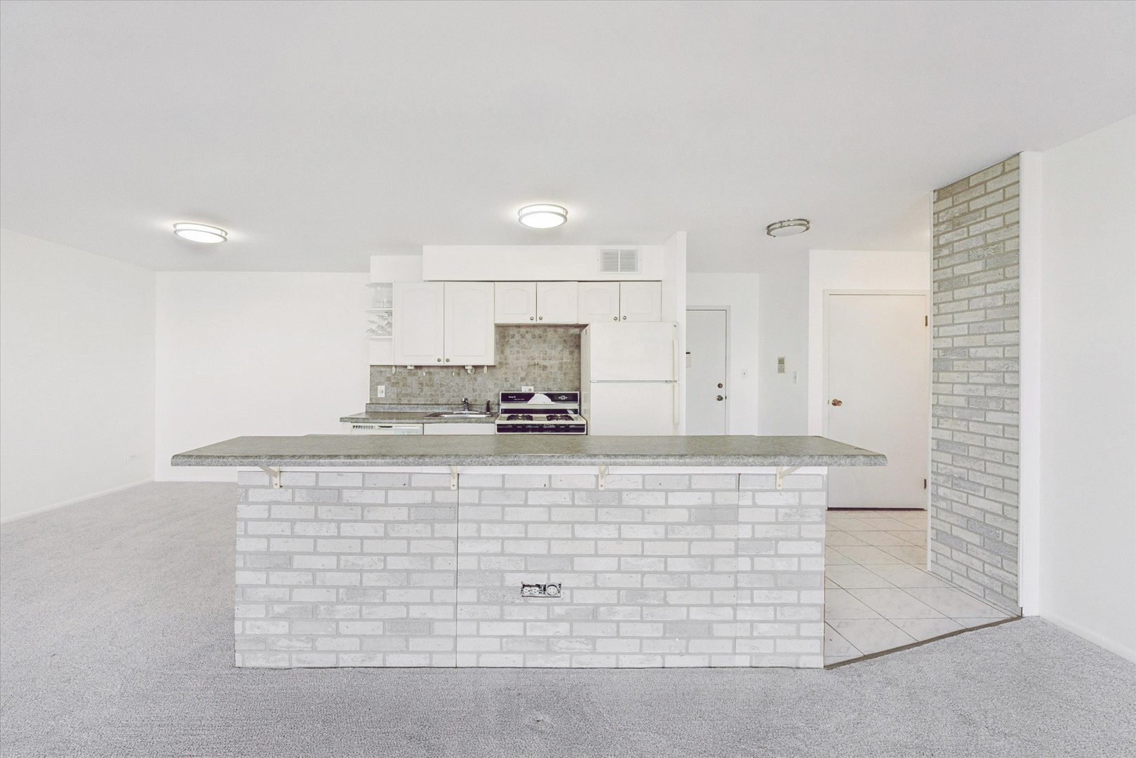 20 North Tower Road, Unit 12L Oak Brook, IL 60523 - Photo 10 of 16 a kitchen with stainless steel appliances granite countertop white cabinets and a granite counter tops