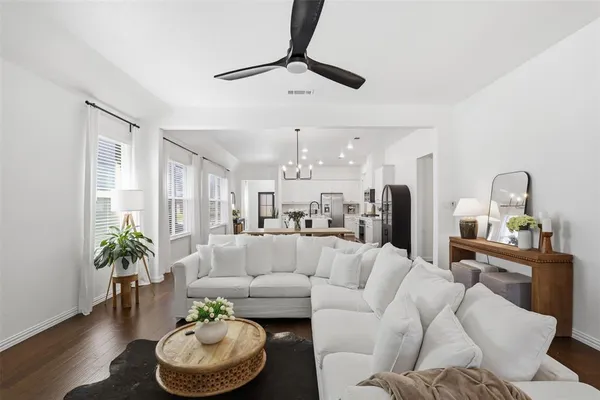 a living room with furniture and a dining room