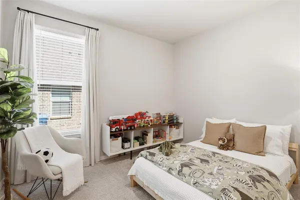 a bed room with a bed and a chair