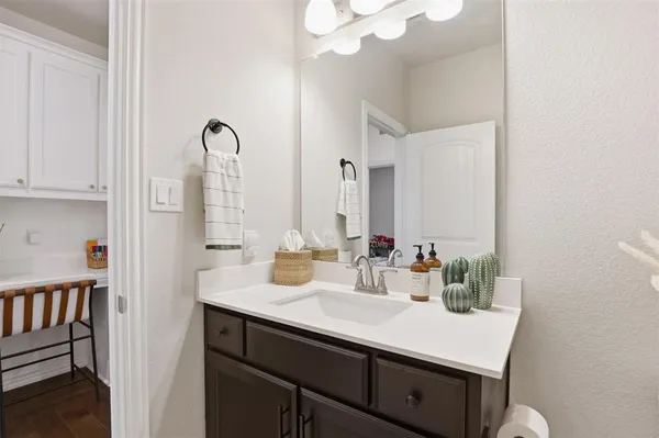 a bathroom with a sink vanity and a mirror